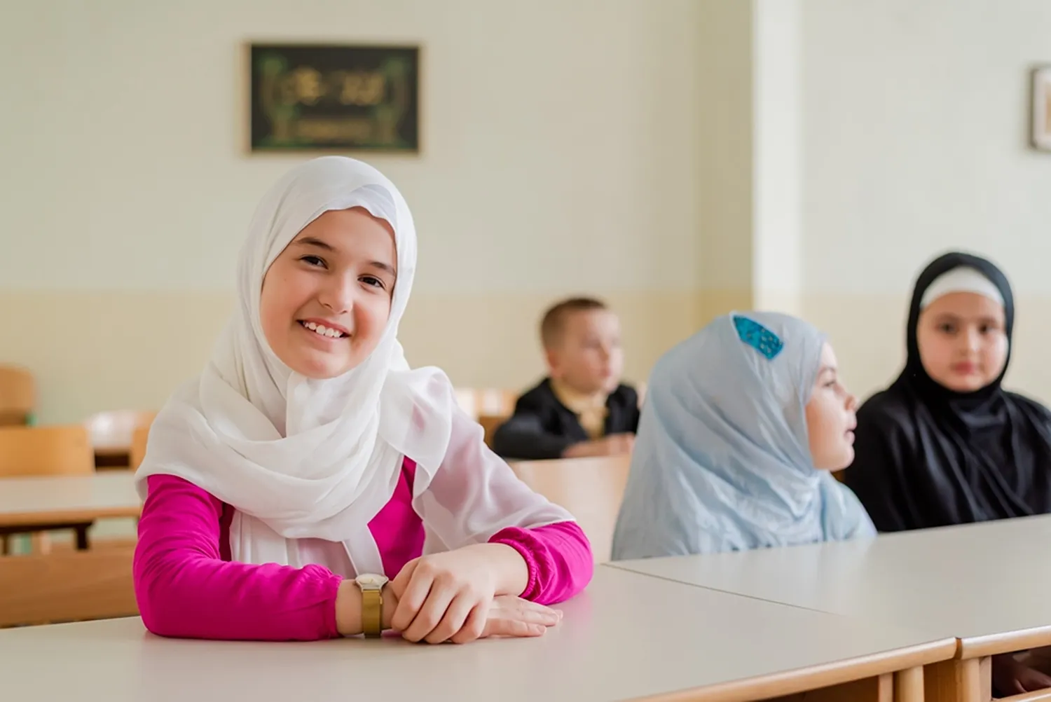 Smiling young Muslim girl student in classroom learning with Quran Janan Academy